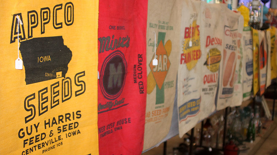 A line of old feed sacks lines a booth.